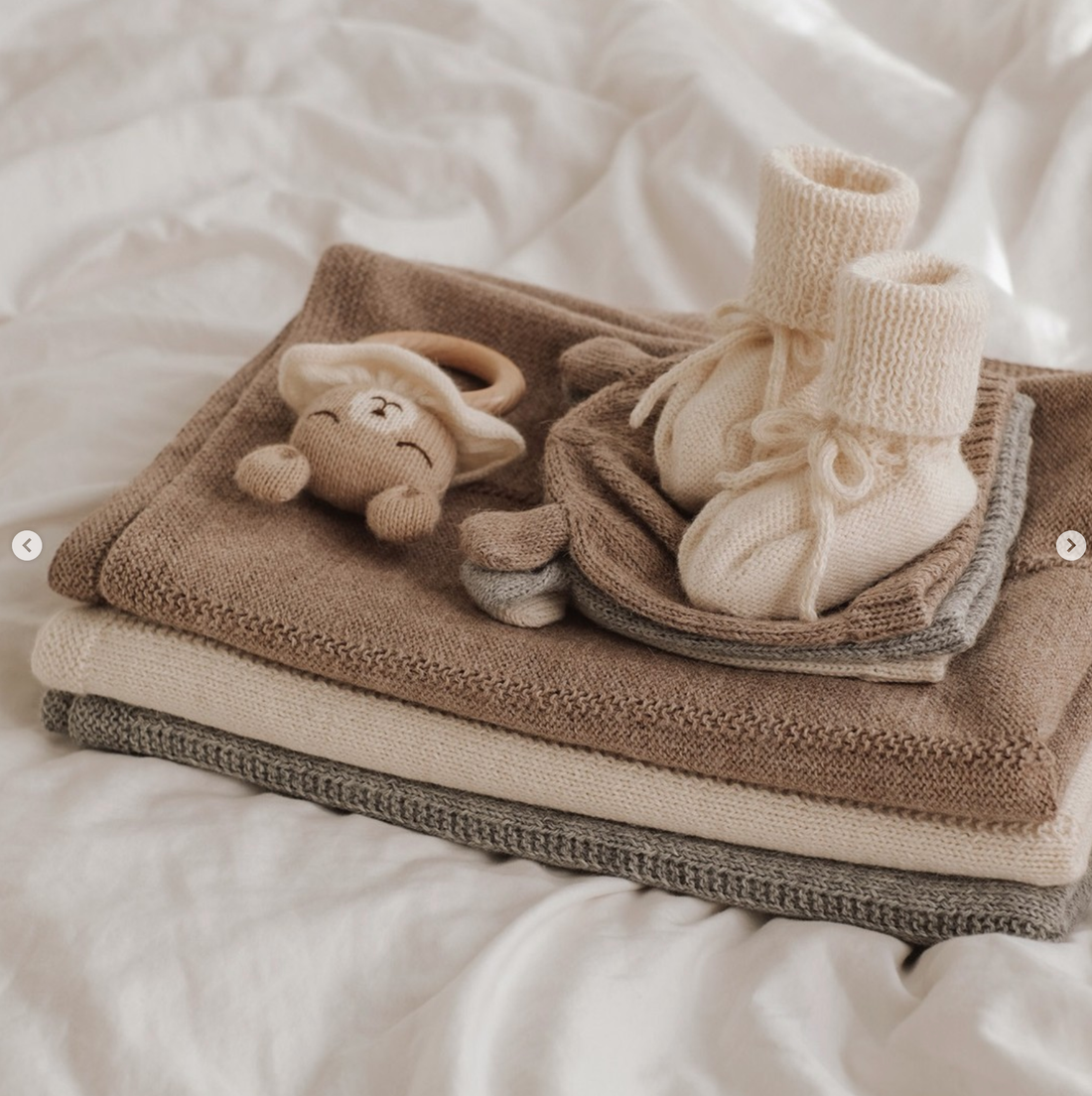 A set of beige baby clothes and booties